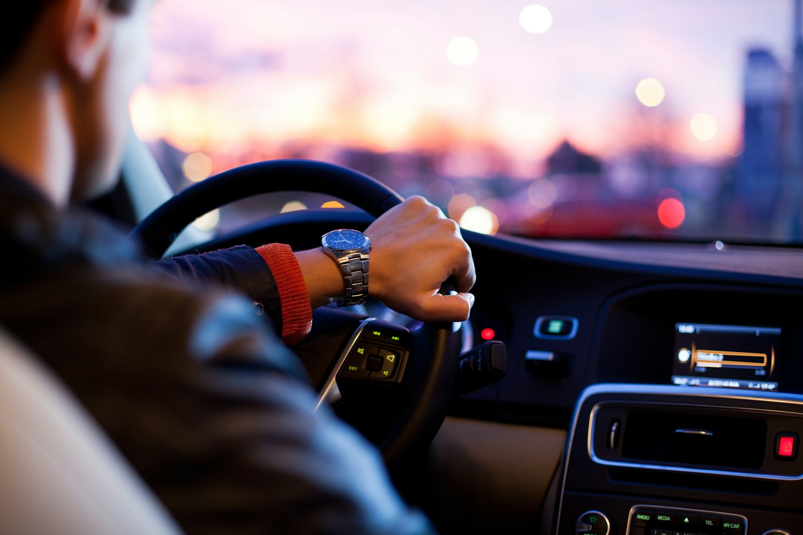 A driver at the wheel at golden hour