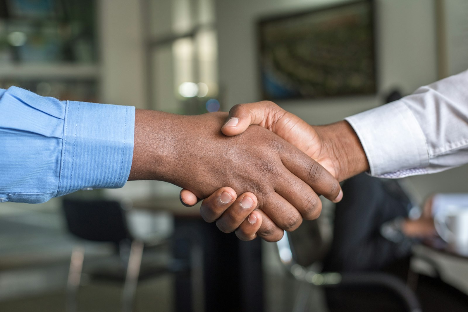 A firm handshake across a desk