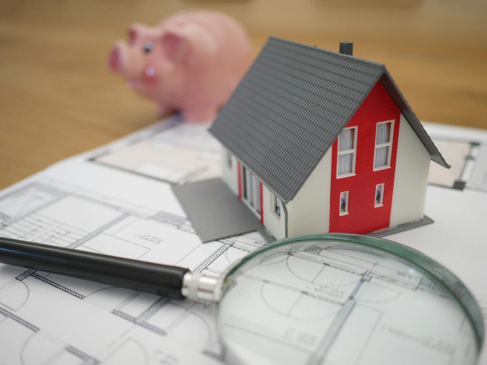A magnifying glass over house plans — the file review
